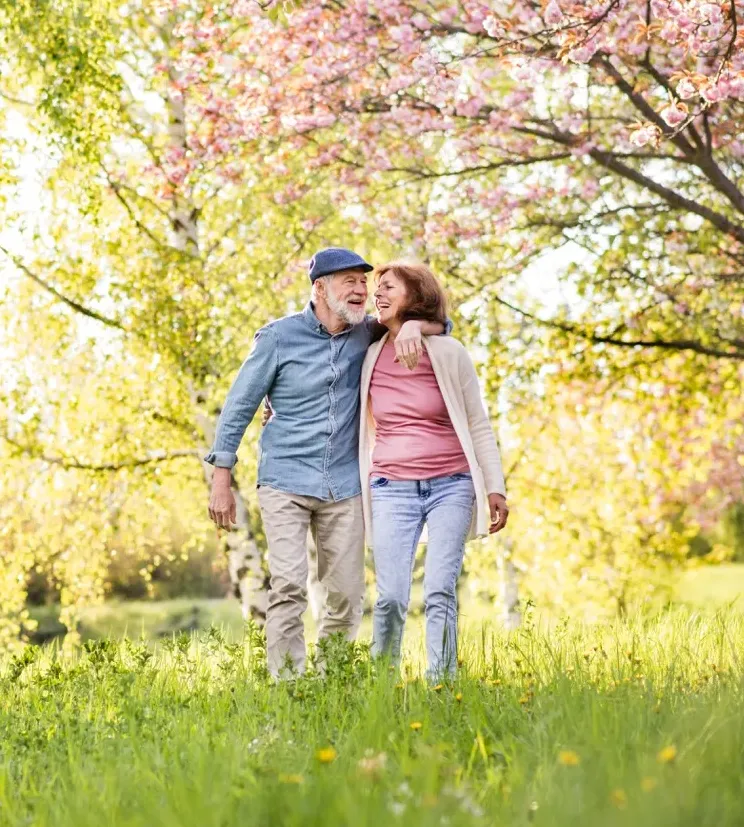 Happy elderly couple walking together on a sunny day